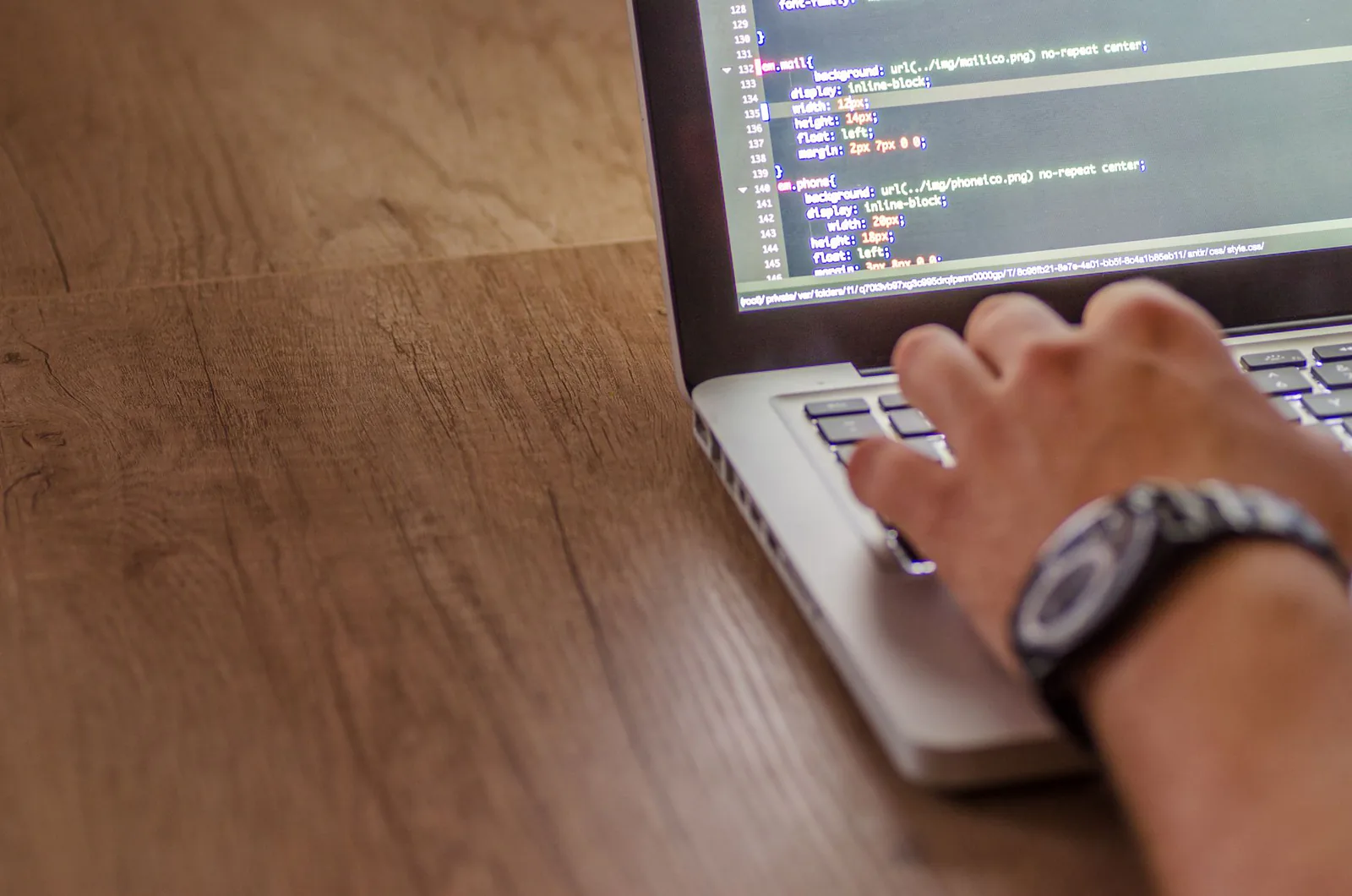 Developer coding a website on a laptop